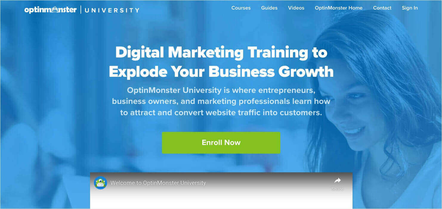 Sales page for OptinMonster University. Heading says, "Digital Marketing Training to Explode Your Business Growth." Subheading says, "OptinMonster University is where entrepreneurs, business owners, and marketing professionals learn how to attract and convert website traffic into customers." A green CTA button says "Enroll Now." You see the top of an embedded YouTube video called "Welcome to OpinMonster University."
