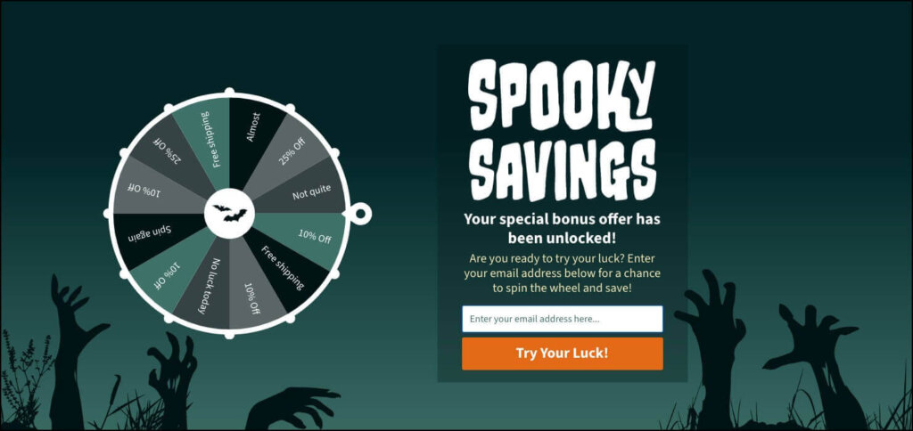 OptinMonster Halloween popup. There are Zombie hands in the background. Text says "Spooky Savings" and there's a coupon wheel. You have to enter an email address to spin the wheel.