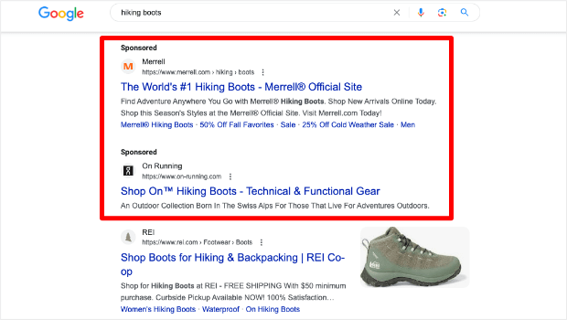 Google search results page for "hiking boots." It shows two sponsored results above the organic results.
